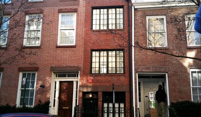 a large brick building with a clock on the front of a window