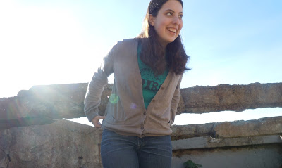 a woman standing in front of a rock