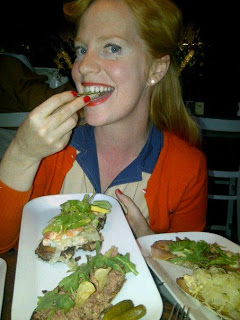 a woman sitting at a table eating food