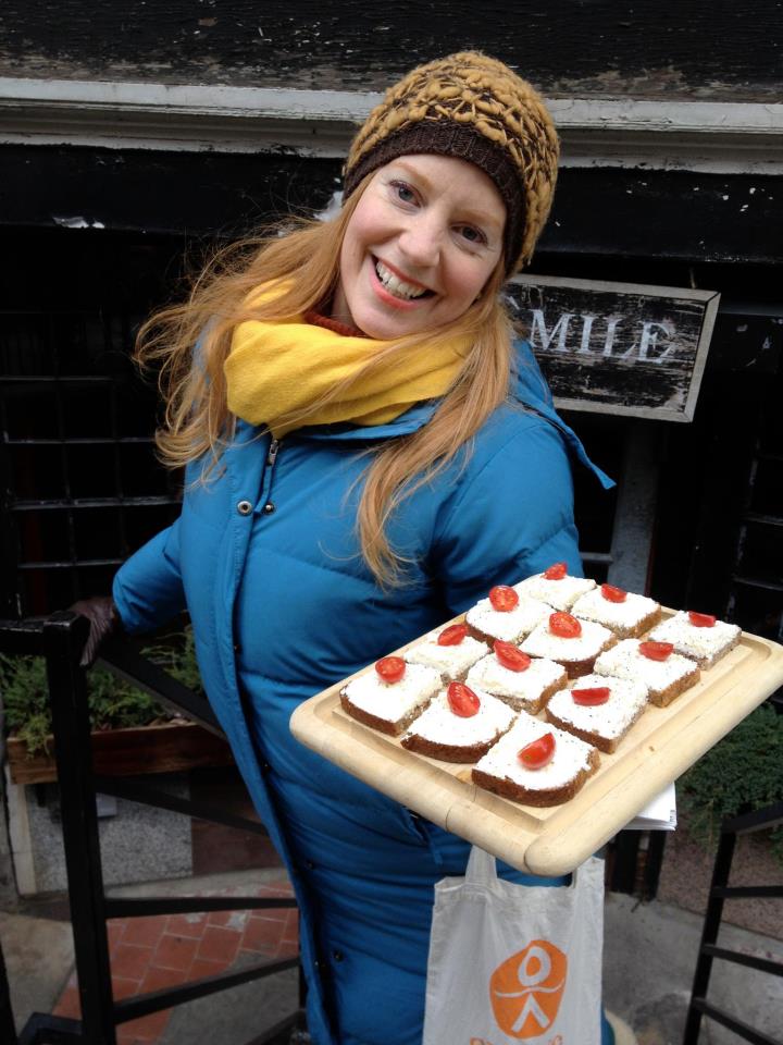 a woman holding a birthday cake
