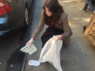a woman sitting on a sidewalk