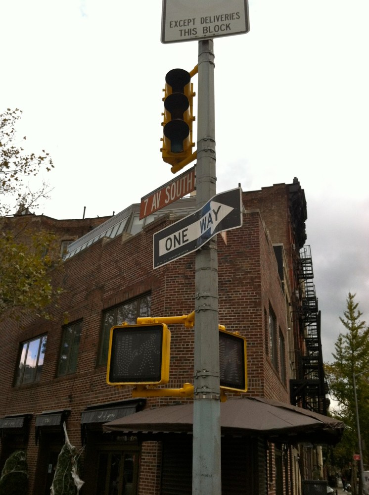 a traffic light and street sign in front of a building