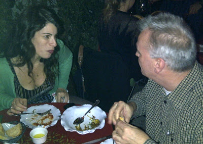 a group of people sitting at a table eating food