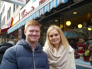 a man and a woman standing in front of a building