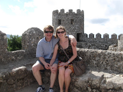 a man and a woman sitting on a rock