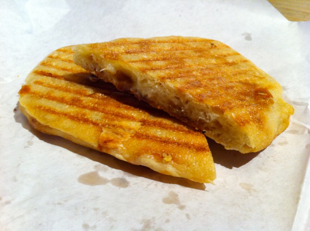 a slice of pizza sitting on top of a piece of paper
