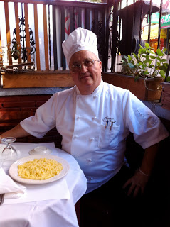 photo-1 a man sitting at a table with a plate of food