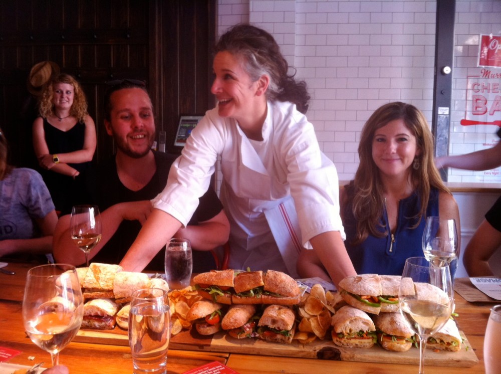 a group of people sitting at a table with food