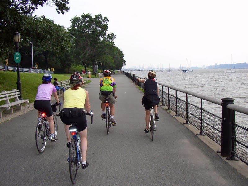 a group of people riding on the back of a bicycle