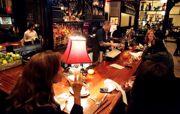 a group of people sitting at a table with wine glasses