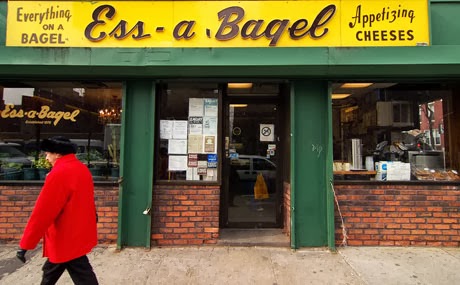 ess-a-bagel_v1_460x285-1 a person standing in front of a store