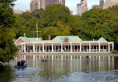 a small boat in a body of water with a city in the background