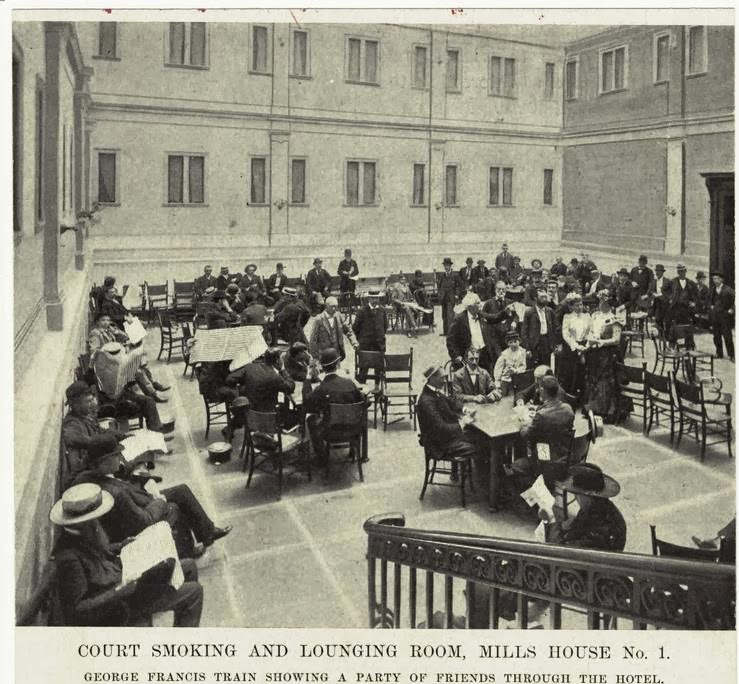 a vintage photo of a group of people standing in front of a building
