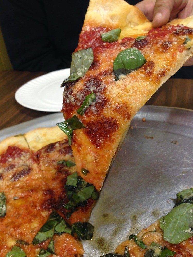 a close up of a plate of food with a slice of pizza