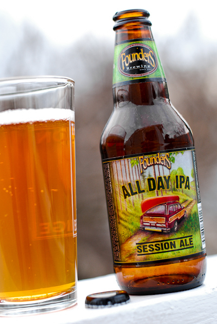 a close up of a bottle and a glass of beer on a table