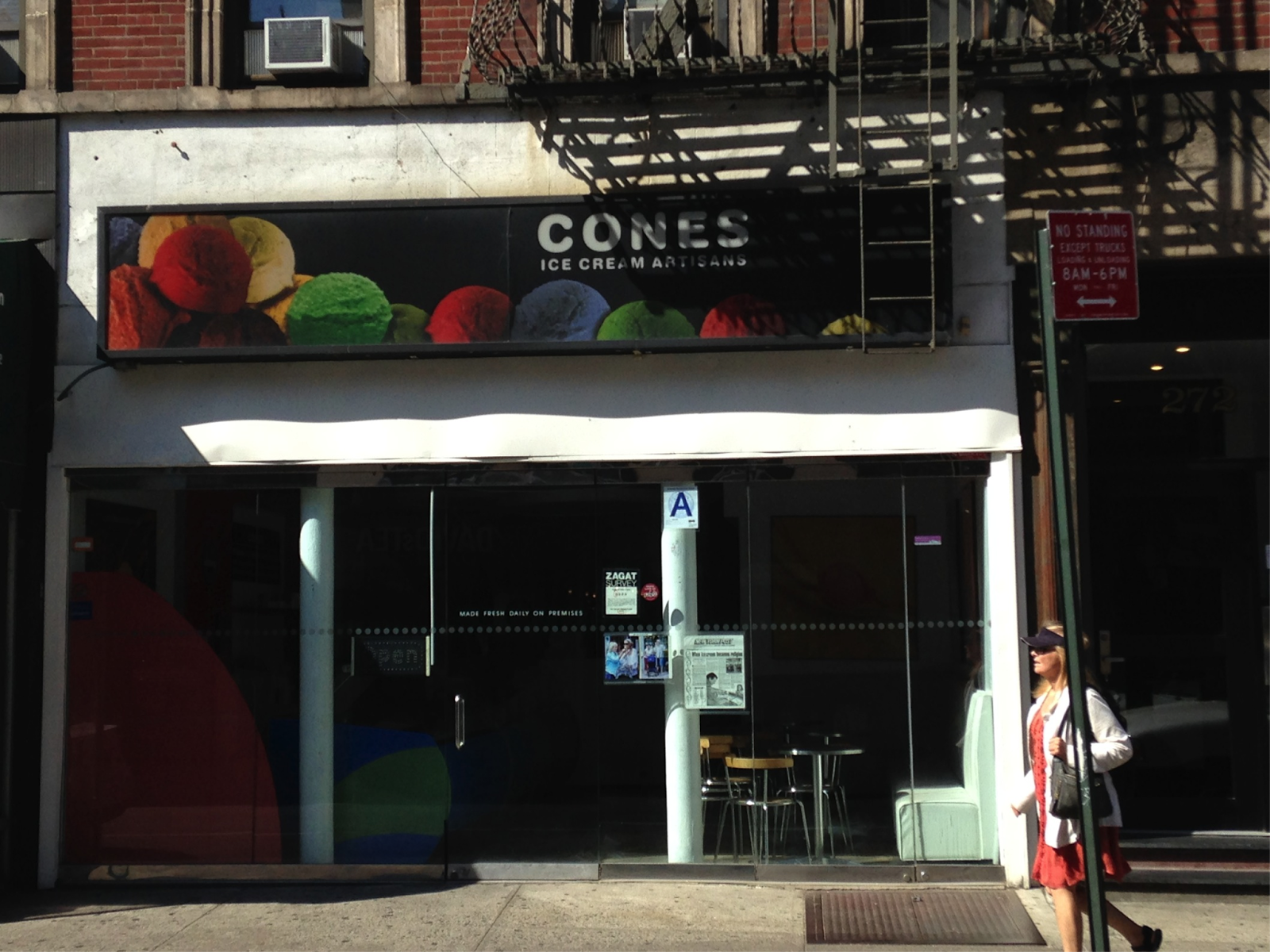 ic4-1 a person walking down a street in front of a store