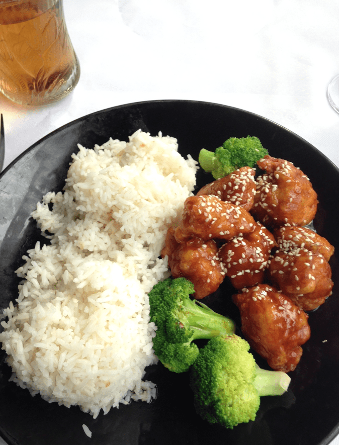 a plate of food with rice meat and broccoli