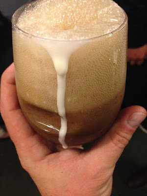 a hand holding a glass of milk