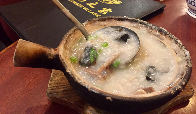 0-2 a bowl of soup sitting on top of a wooden table