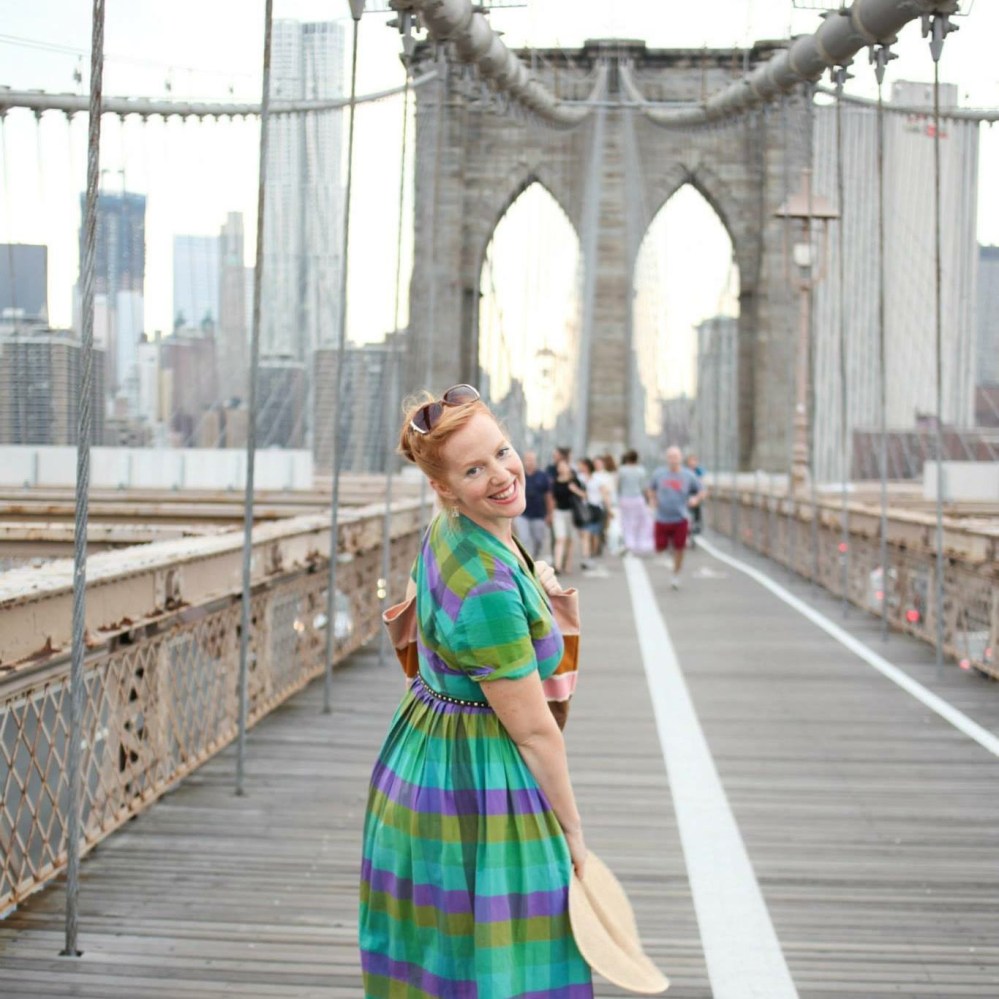 a person standing next to a bridge