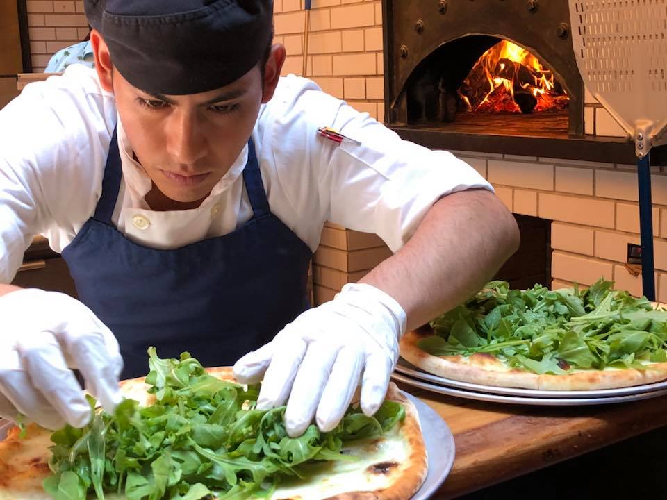 a man cutting food on a table