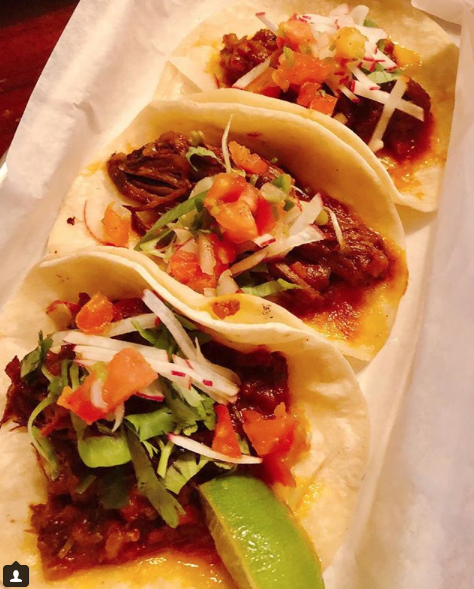 a plate of hot dogs with different toppings