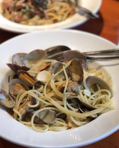 a bowl of pasta sits on a plate