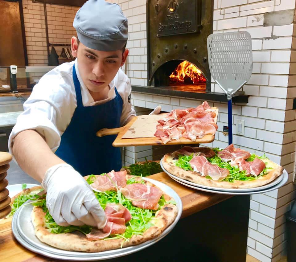 a woman sitting at a table with a plate of food