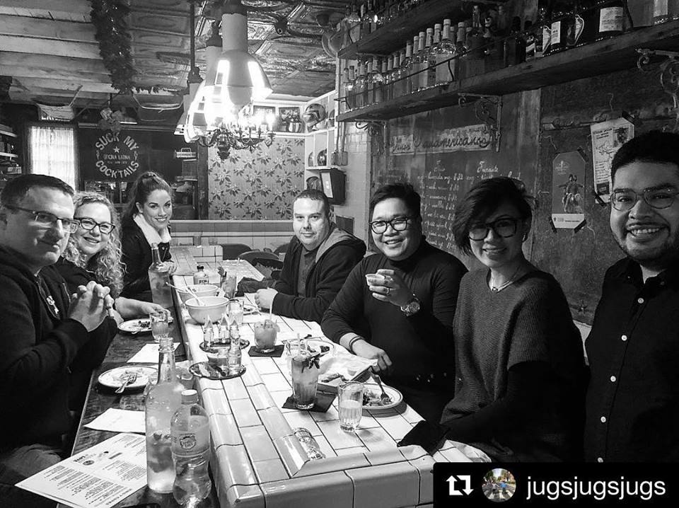 a group of people sitting at a table posing for the camera