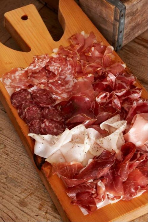a pizza sitting on top of a wooden cutting board