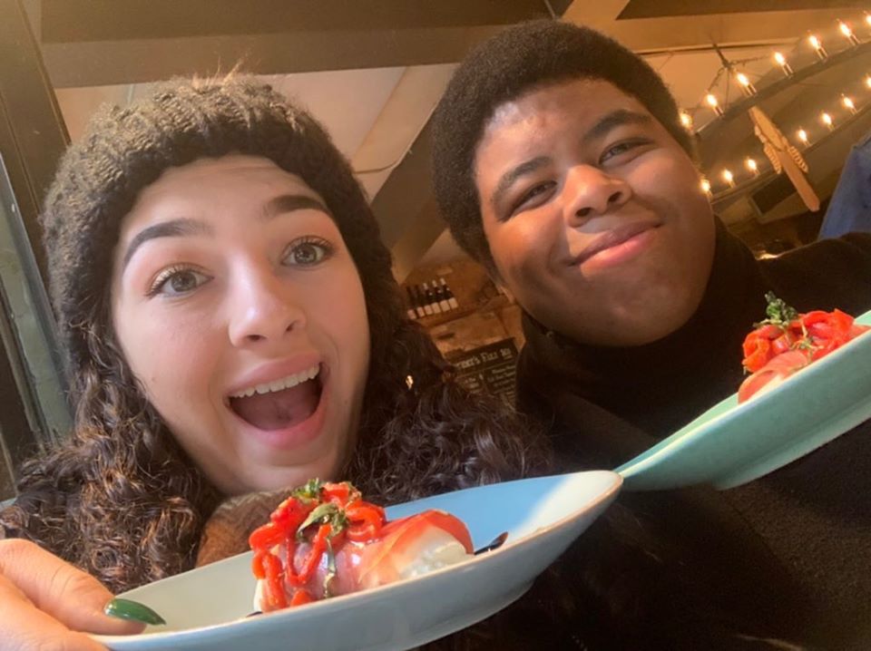 a woman sitting at a table with a plate of food