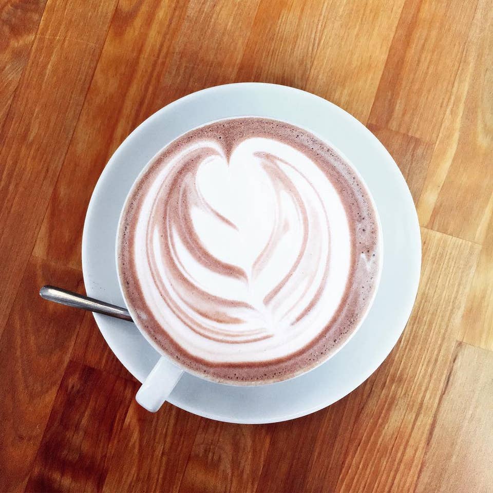 image a cup of coffee sitting on top of a wooden table