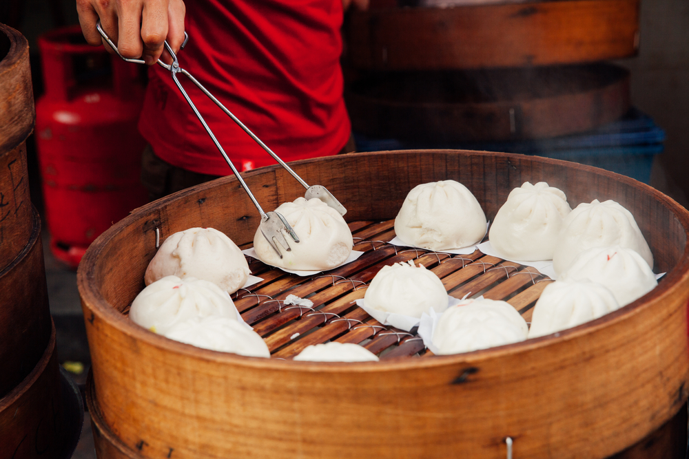 Steamed buns food stall in Chinatown, Kuala Lumpur, Malaysia a bowl of food on a table