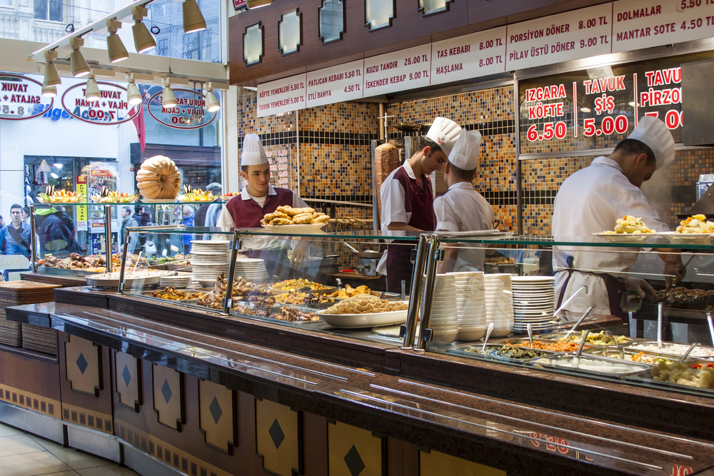 food-tour-how-to-plan-your-ideal-culinary-experience1 a group of people standing around a counter in a store