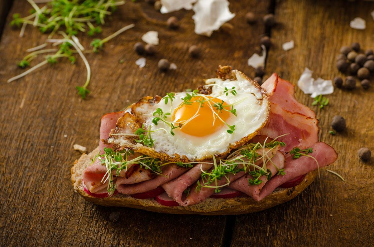 breakfast-in-new-york-city-what-do-new-yorkers-really-eat-img a sandwich sitting on top of a cutting board