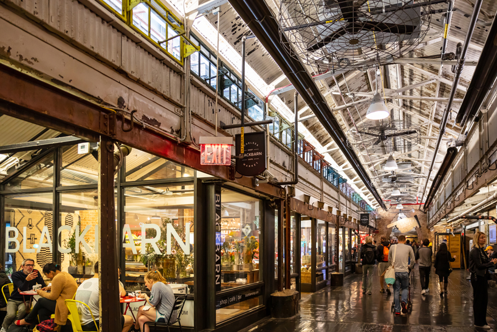 is-the-chelsea-market-food-tour-worth a group of people standing in a train station
