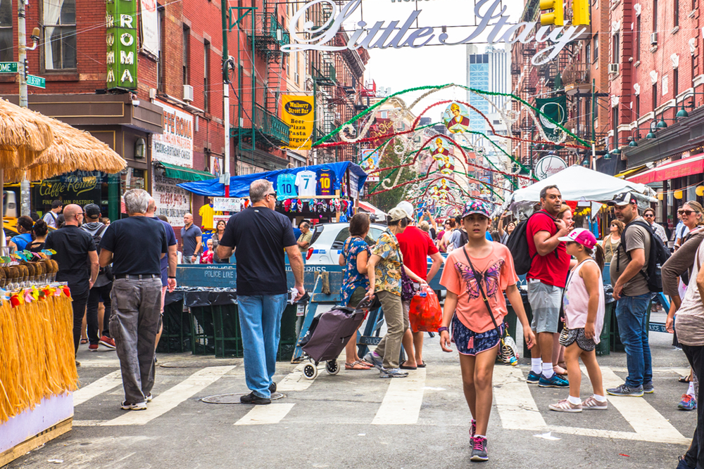 little-italy-tour-in-nyc-your-guide-to-exploring a group of people walking on a city street