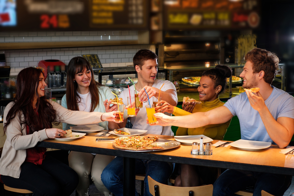 what-to-expect-during-brooklyn-food-tour a group of people sitting at a table