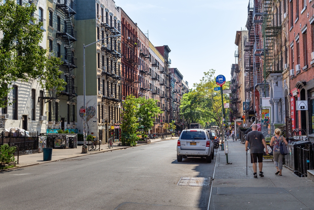 nolita-neighborhood-guide a group of people walking on a city street