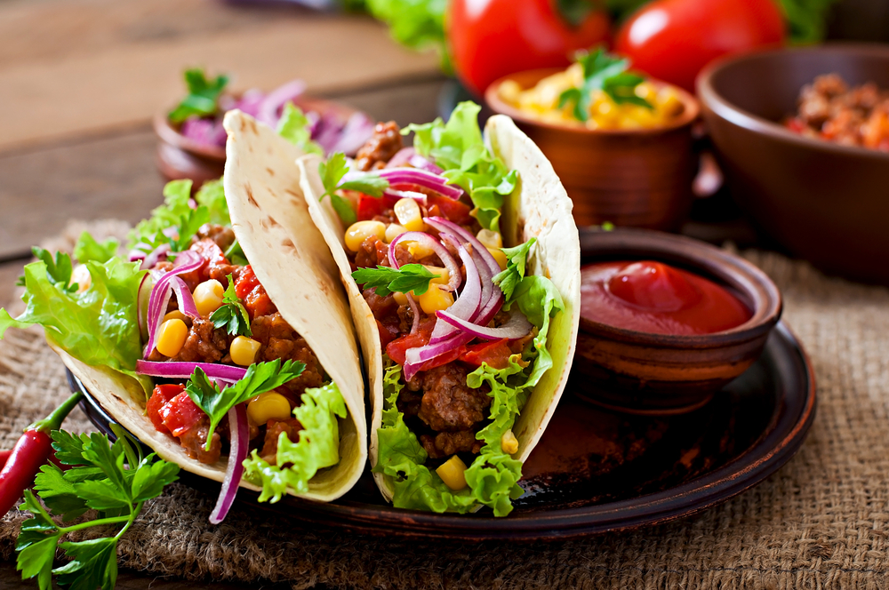 x-best-tacos-in-nyc-that-will-have-you-coming-back-for-more a plate of food with a sandwich and a salad