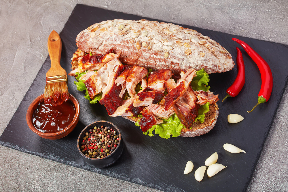 x-mouthwatering-sandwich-places-you-cant-resist-in-nolita a sandwich sitting on top of a plate of food