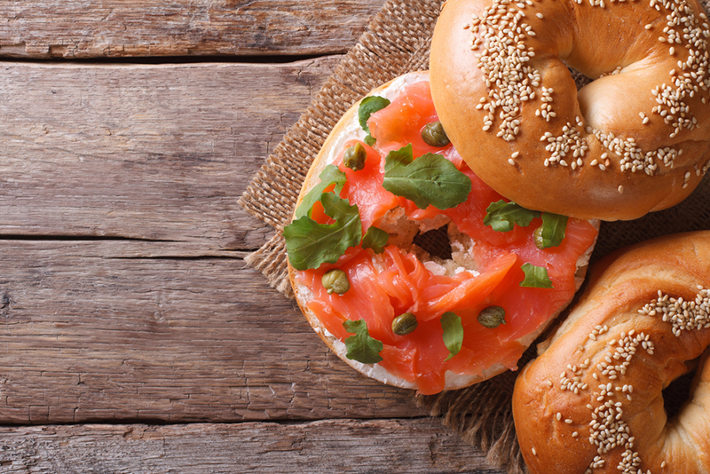 5-best-bagels-in-nyc-that-will-leave-you-wanting a donut sitting on top of a wooden table