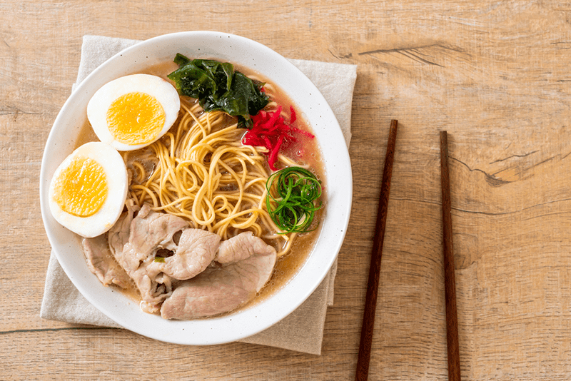 5-best-ramen-restaurants-in-nyc-to-try-right a plate of food sitting on top of a wooden table