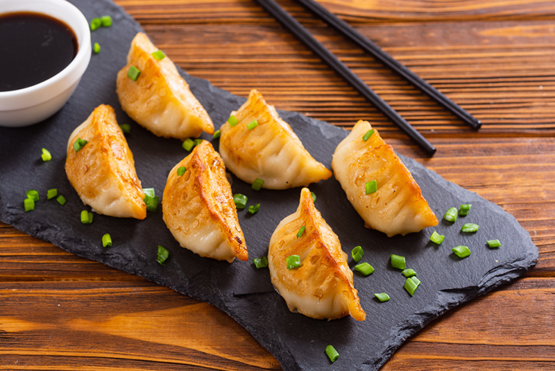 6-best-ethnic-food-destinations-in-nyc-you-need food on a wooden cutting board