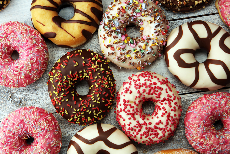 x-best-donut-spots-in-nyc-for-ultimate-sweetness1 a pink box filled with different kinds of donuts