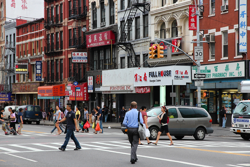 7-must-visit-destinations-for-a-chinatown-food-tour a group of people walking down a busy city street