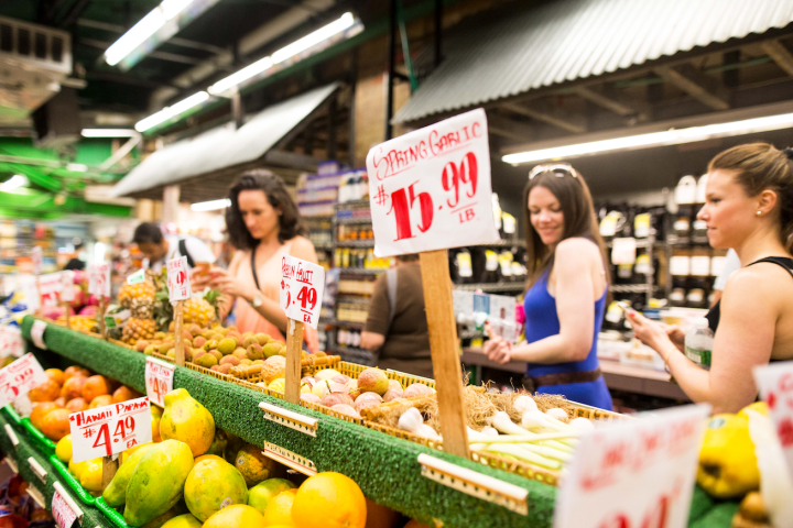 a store filled with lots of fruit and vegetables on display