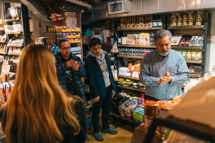a group of people standing in front of a store