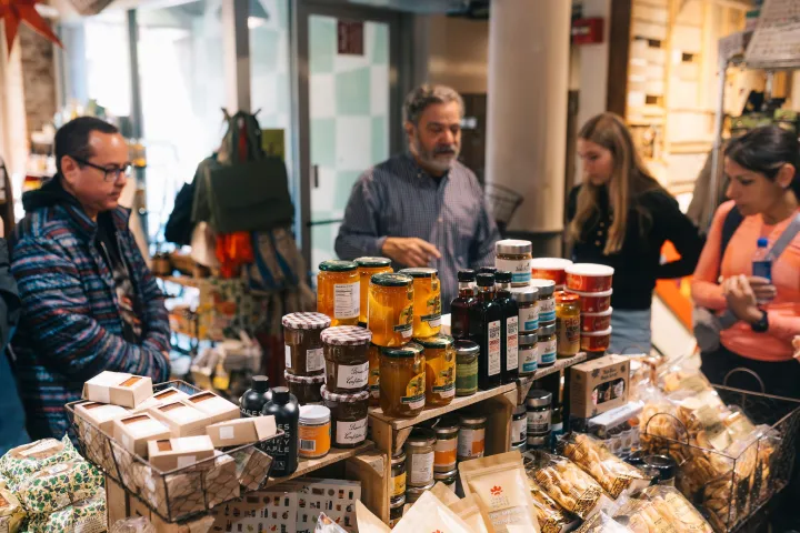 a group of people preparing food on a table