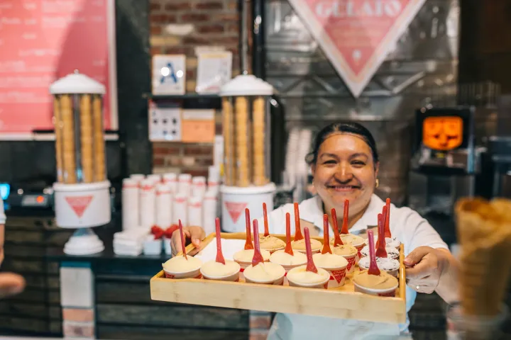a person sitting at a table in front of a building